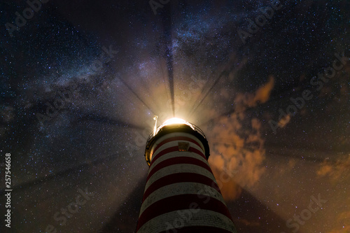 The milky way over lighthouse photo