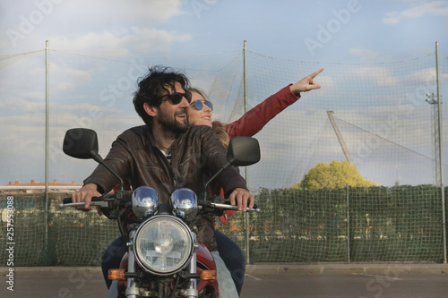 Couple of motorcyclists on a retro style motorbike © Monic249