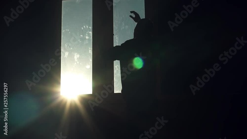 Nervous silhouette young man stand near window walk sad nervous thinking sunset sunlight tired angry suicide in room dark close up slow motion