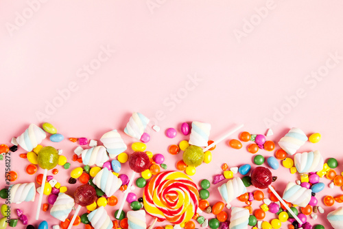 Colorful lollipops and different colored round candy. Top view.