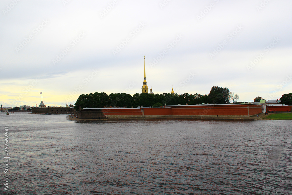 A view of the Peter and Paul Fortress on a summer day from the bridge over the Neva River