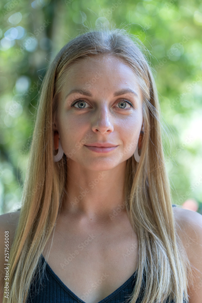 Beautiful caucasian blonde girl in nature background. A portrait of a young woman in tropical garden, Thailand Beautiful caucasian blonde girl in nature background. A portrait of a young woman in tropical garden, Thailand