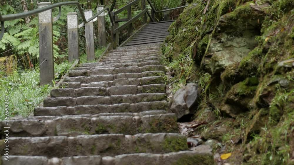 Stone steps steeply leading upwards to a wooden rest area. PAN UP SHOT. Stone steps steeply leading upwards to a wooden rest area. PAN UP SHOT.