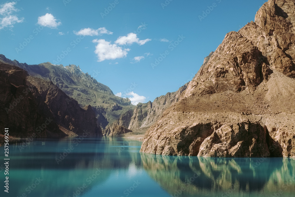 reflection in the water of Attabad Lake, surrounded by mountains in Karakoram range. Gojal Hunza, Gilgit Baltistan, Pakistan. reflection in the water of Attabad Lake, surrounded by mountains in Karakoram range. Gojal Hunza, Gilgit Baltistan, Pakistan.