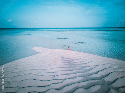 Aerial drone photo - A woman in the Maldives islands.