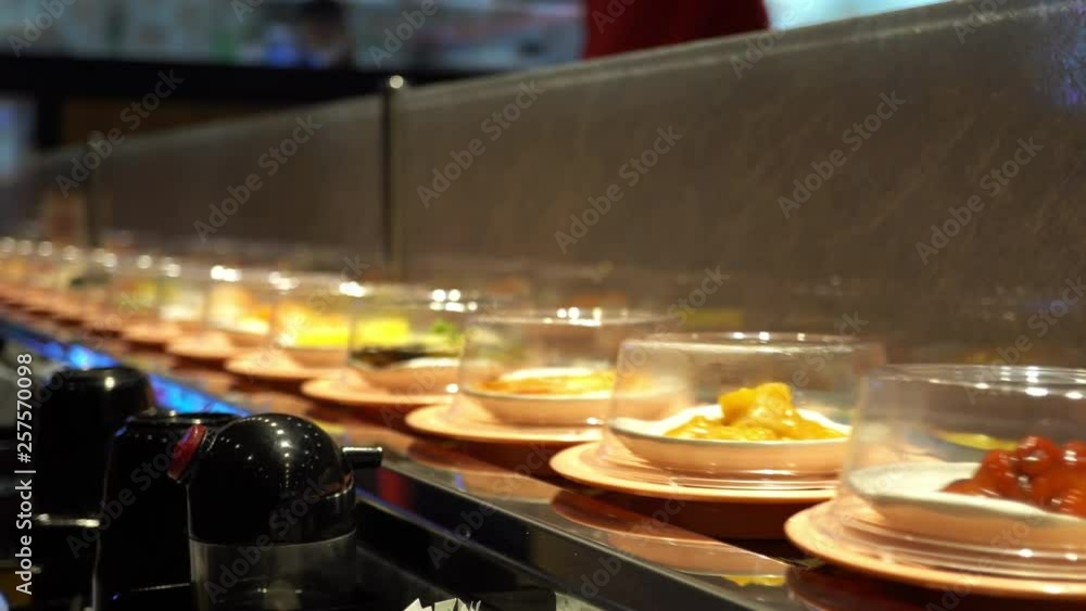 Food dishes and desserts rolling on conveyor belt restaurant Food dishes and desserts rolling on conveyor belt restaurant