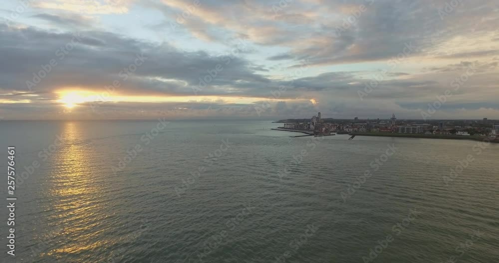 Aerial: The boulevard, beach and city of Vlissingen during sunset. Aerial: The boulevard, beach and city of Vlissingen during sunset.