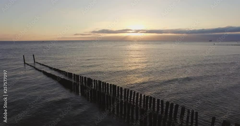 Aerial: Wave breakers on a beach in Zeeland, the Netherlands. Aerial: Wave breakers on a beach in Zeeland, the Netherlands.