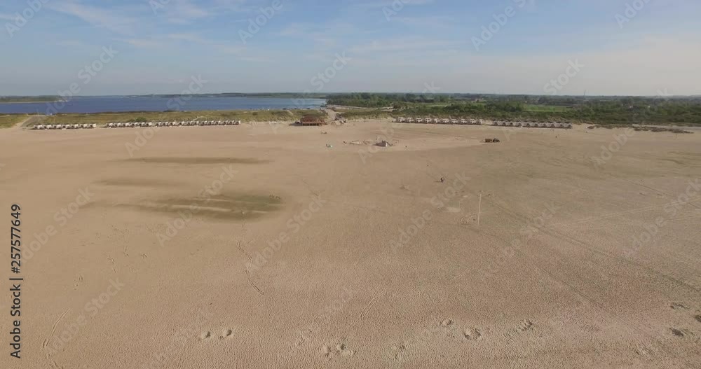 Aerial: A beach club on a large beach in the Netherlands. Aerial: A beach club on a large beach in the Netherlands.