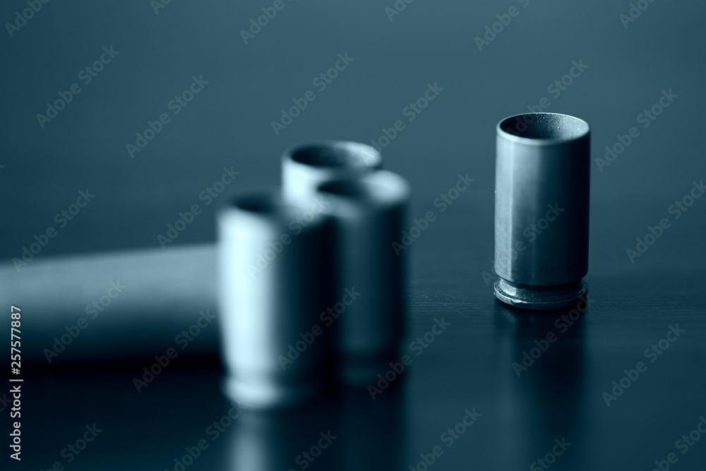 Empty old bullet cartridges close up. Blue color toned Empty old bullet cartridges close up. Blue color toned