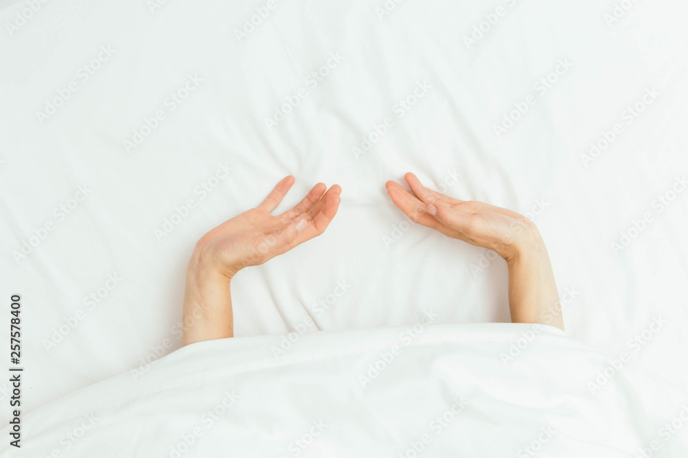 Caucasian Hands Peeking Out From Under Bedsheets Caucasian Hands Peeking Out From Under Bedsheets