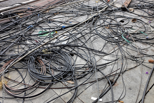 Many confused electrical wires on ground.