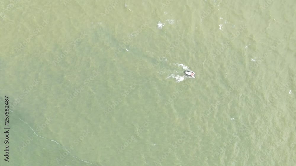 Top aerial view of a small traditional wooden fisher boat in the ocean Top aerial view of a small traditional wooden fisher boat in the ocean