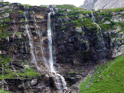 Waterfall Oberer Jetzbachfall in the alpine valley of Im Loch - Canton of Glarus, Switzerland photo