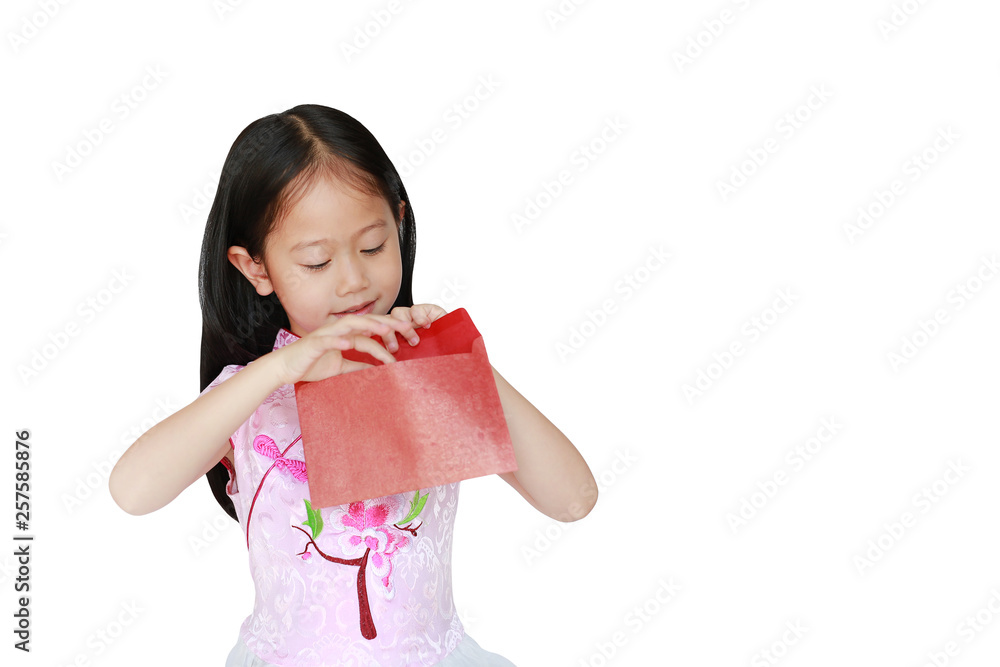 Happy little Asian child girl wearing pink traditional cheongsam dress smiling while receiving Chinese New Year red envelope packet isolated on white background. Happy chinese new year concept. Happy little Asian child girl wearing pink traditional cheongsam dress smiling while receiving Chinese New Year red envelope packet isolated on white background. Happy chinese new year concept.