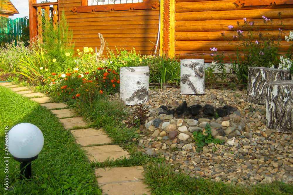 landscape design with a walkway and a place for a fire