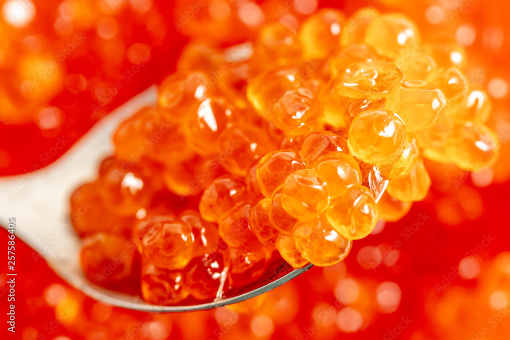 Red caviar on the spoon as a background Red caviar on the spoon as a background