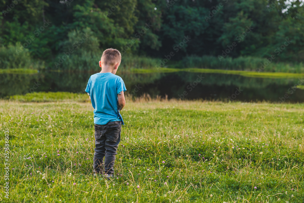 little offended boy standing away alone little offended boy standing away alone