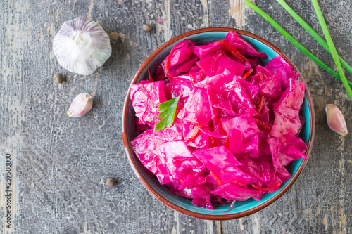 Marinated white cabbage with beet and spices with pickled parsley leaves