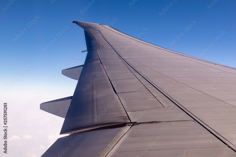 Flying wing passenger aircraft on a background of blue sky and clouds