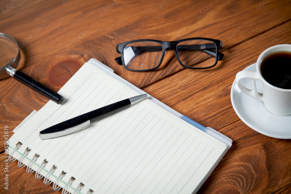 cup of coffee on the table,glasess,pen cup of coffee on the table,glasess,pen