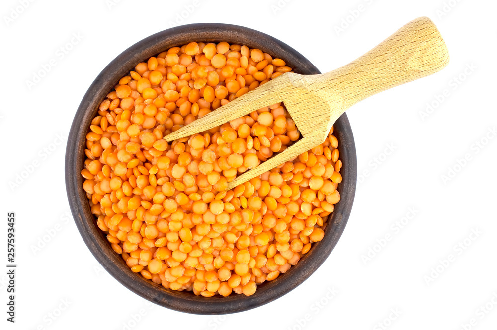 Red lentils in plate and scoop isolated on white background Red lentils in plate and scoop isolated on white background