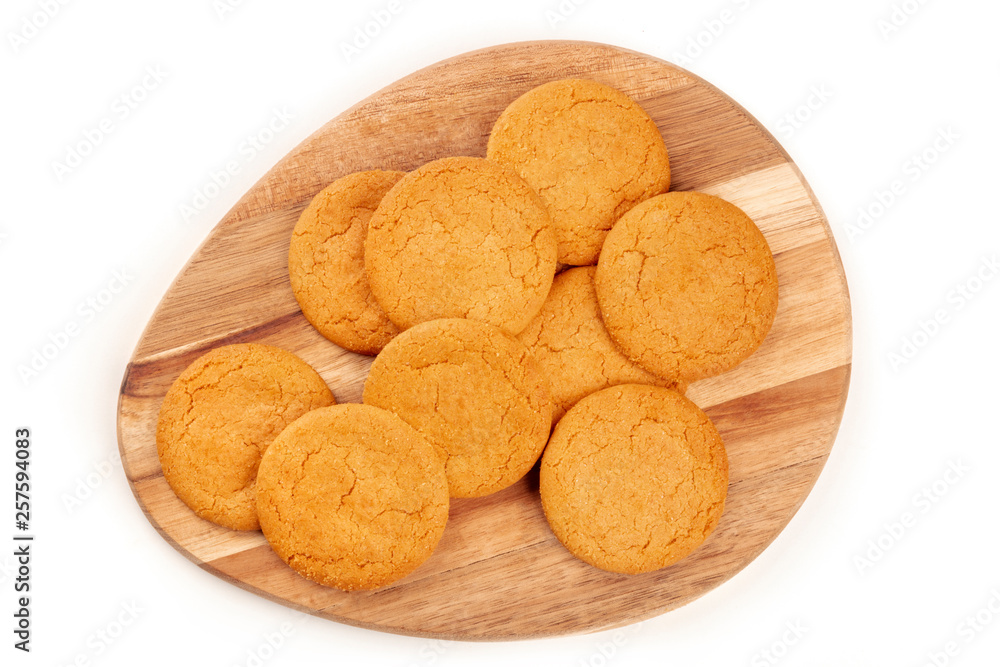 Gingersnaps on a wooden tray, shot from above on a white background Gingersnaps on a wooden tray, shot from above on a white background