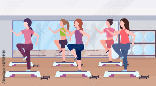 sports women group doing squats on step platform girls training in gym aerobic legs workout healthy lifestyle concept flat modern health club studio interior horizontal