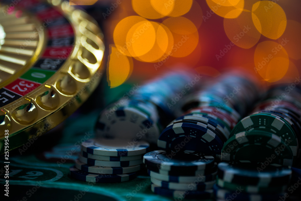 Casino theme. High contrast image of casino roulette, and poker chips Casino theme. High contrast image of casino roulette, and poker chips