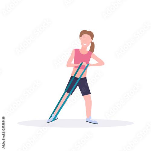 sporty woman doing exercises with resistance band girl training in gym stretching workout healthy lifestyle concept flat white background