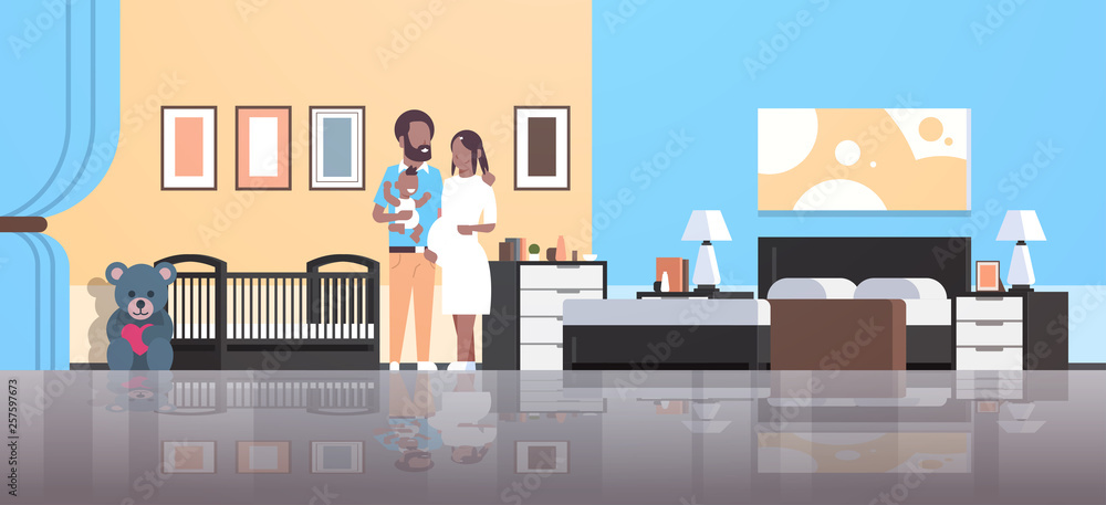 husband with pregnancy wife holding newborn baby son standing near crib happy african american family parenthood concept modern home bedroom interior flat full length husband with pregnancy wife holding newborn baby son standing near crib happy african american family parenthood concept modern home bedroom interior flat full length