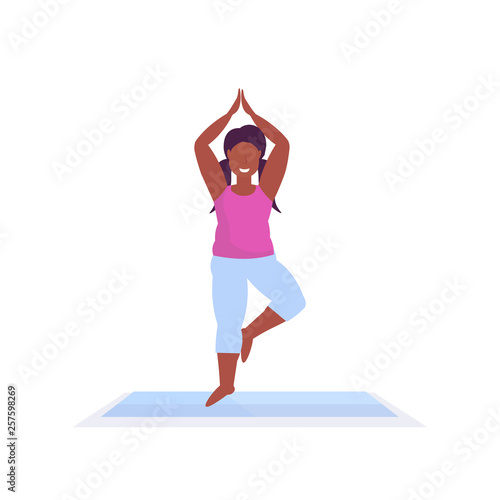 sporty woman doing yoga exercises african american girl meditating standing in tree position working out fitness healthy lifestyle concept female character full length white background