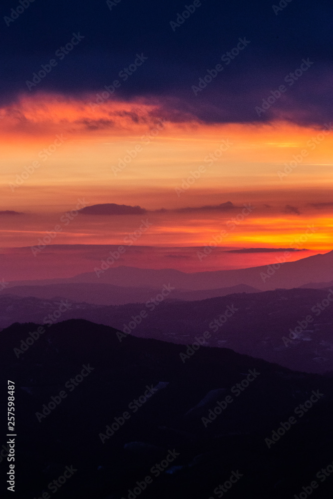 Beautifully colored sky at dusk, with mountains layers Beautifully colored sky at dusk, with mountains layers