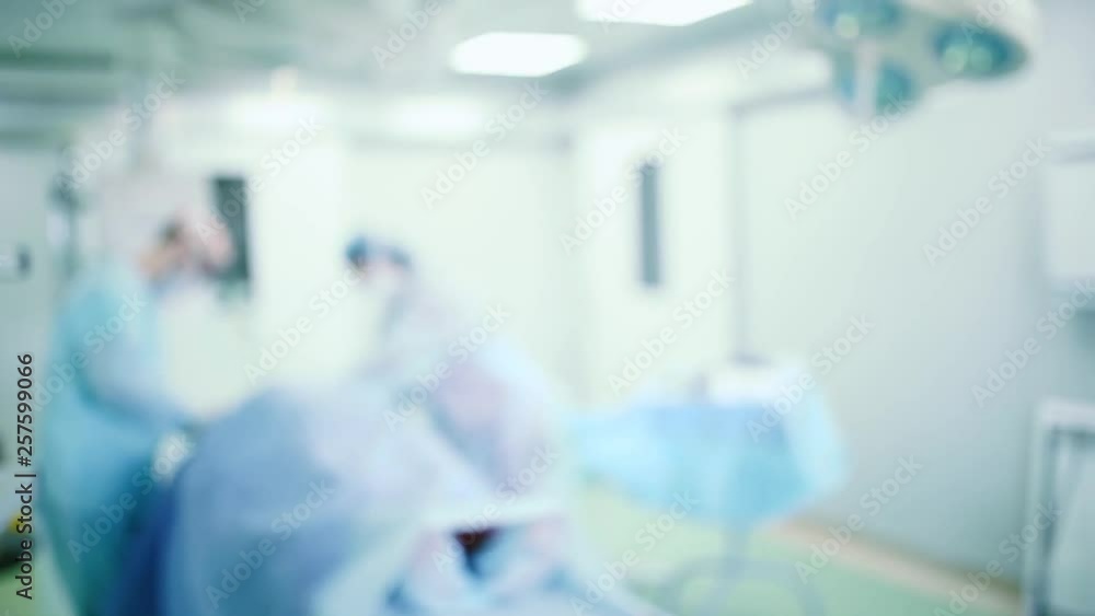 Blurred background of surgical operation of a surgeon in a medical operating room. Blurred background of surgical operation of a surgeon in a medical operating room.