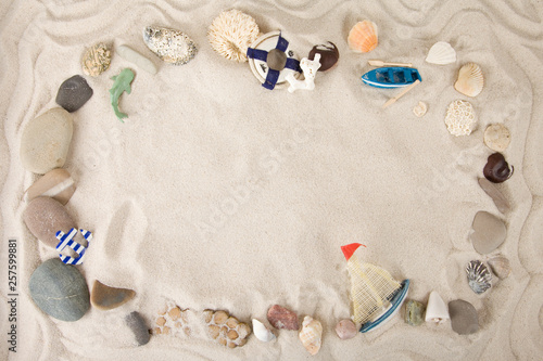 Beach summer theme. Summer background with sea shells and red star with sand on blue wooden planks. Copy space. Marine theme