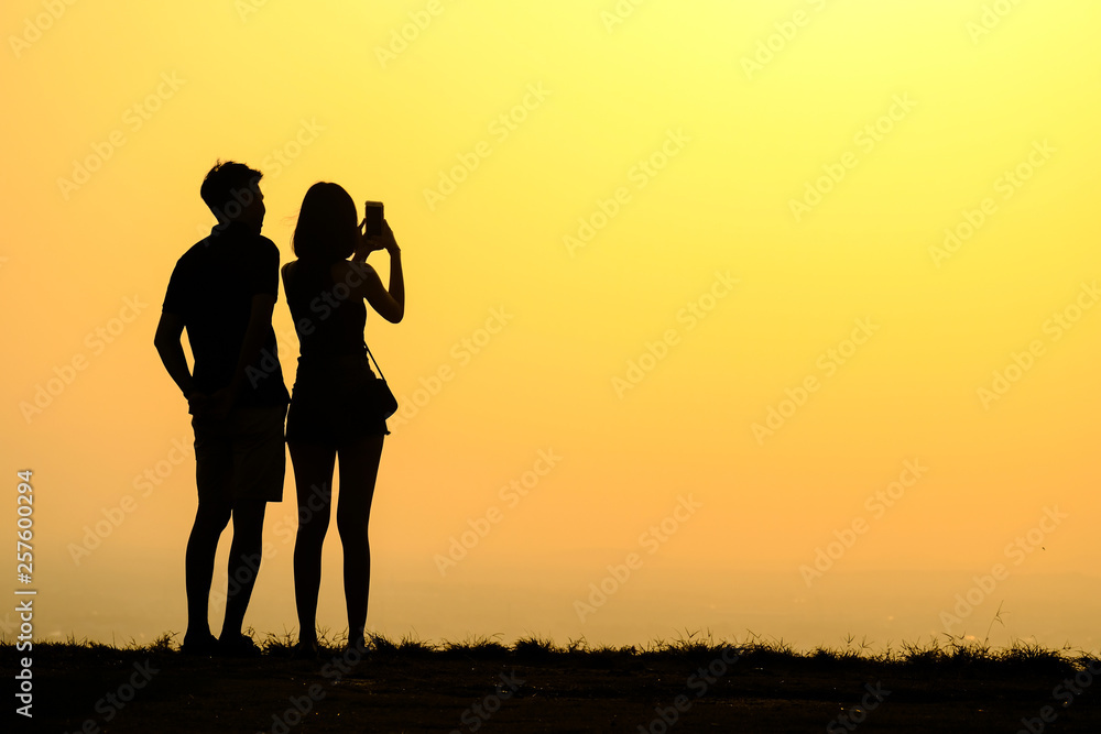 Silhouette young couple on sunset time.