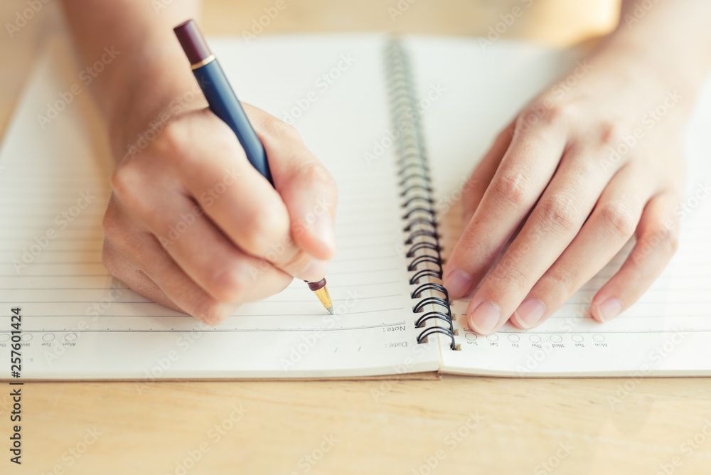 female hands with pen writing on notebook - Image female hands with pen writing on notebook - Image