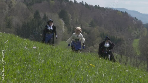 Fantasy Adventure Group running on meadow – Slow Motion photo