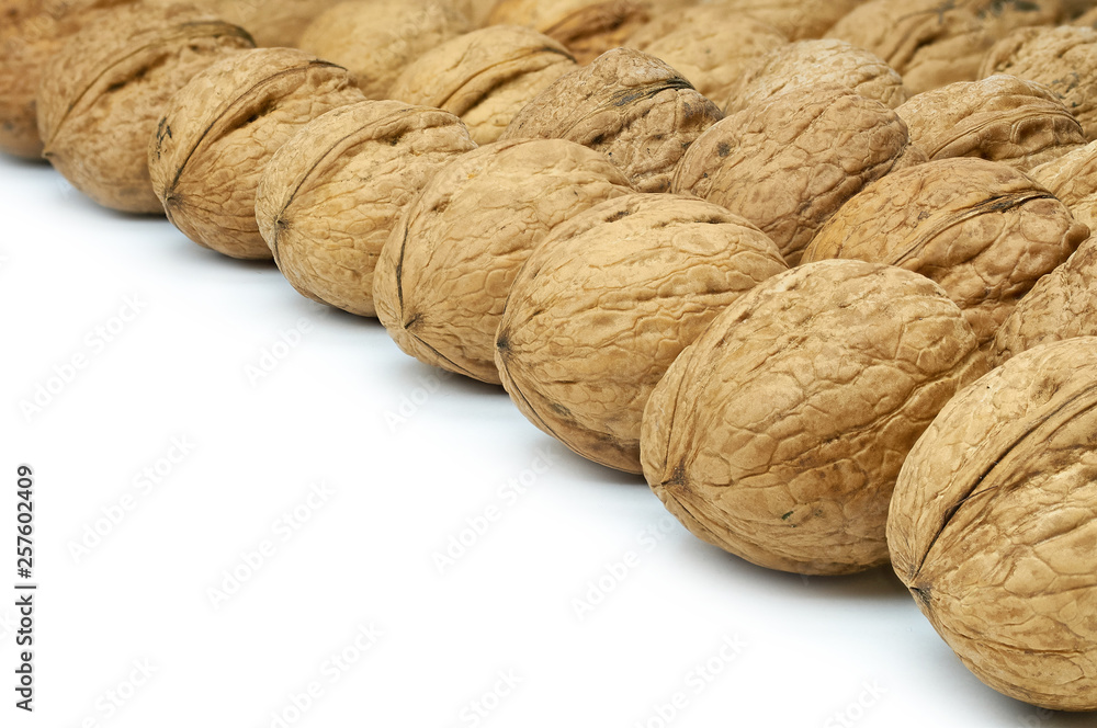 Walnuts on natural burlap, walnut kernels in a wicker basket, nutty background Walnuts on natural burlap, walnut kernels in a wicker basket, nutty background