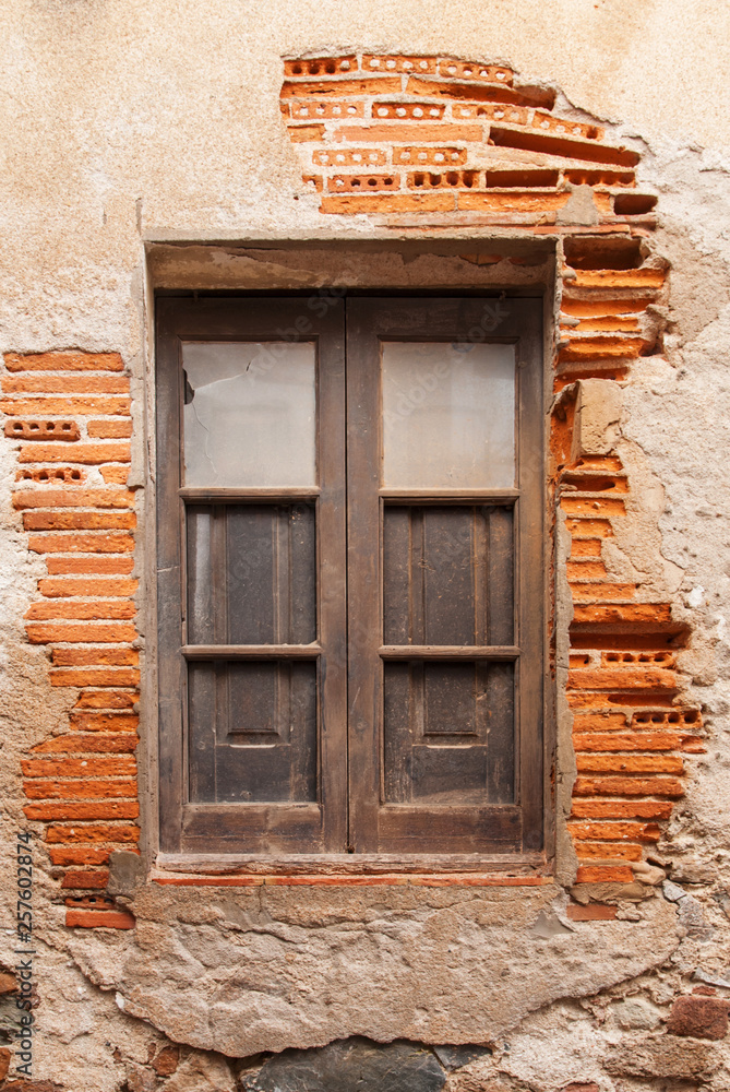 Wooden window in the wall of the ancient building