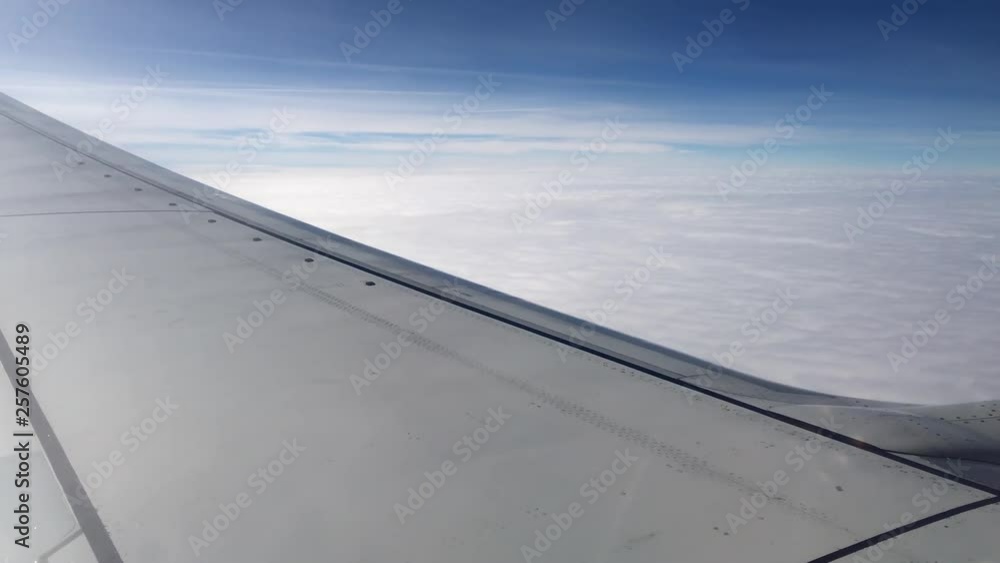Aerial view of clouds and sky as seen through window of an airplane. 4K Aerial view of clouds and sky as seen through window of an airplane. 4K
