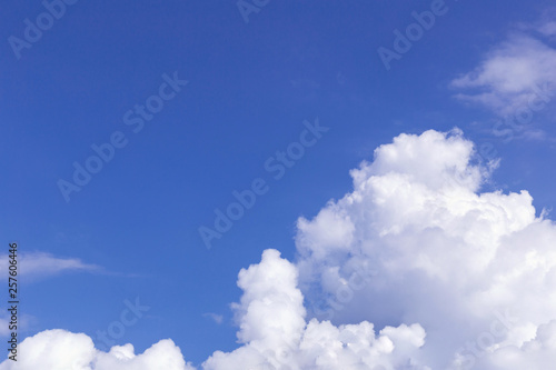 Blue sky background with white clouds, rain clouds on sunny summer or spring day.