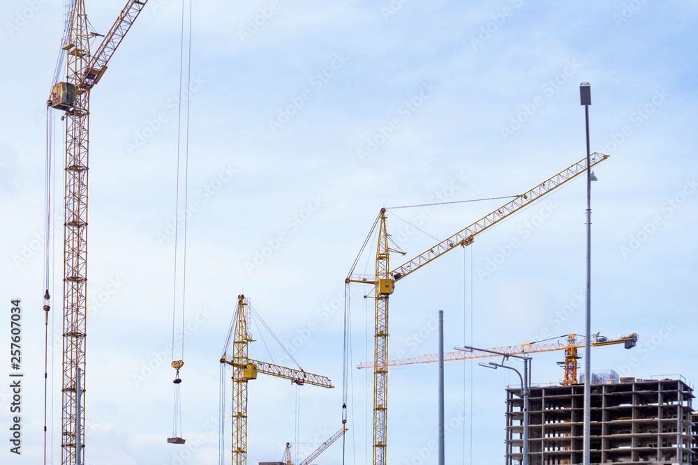 construction cranes build houses