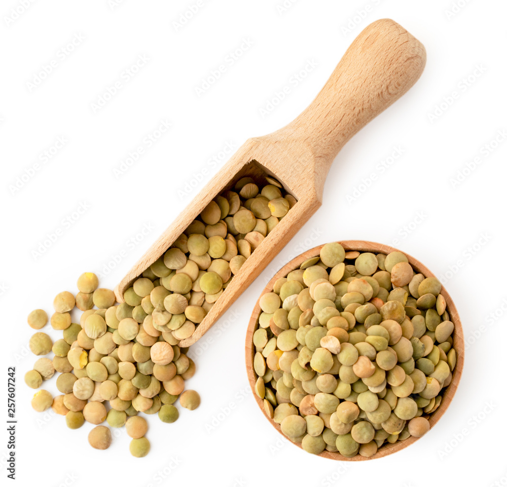 Lentils in a wooden dish on a white. The form of the top. Lentils in a wooden dish on a white. The form of the top.