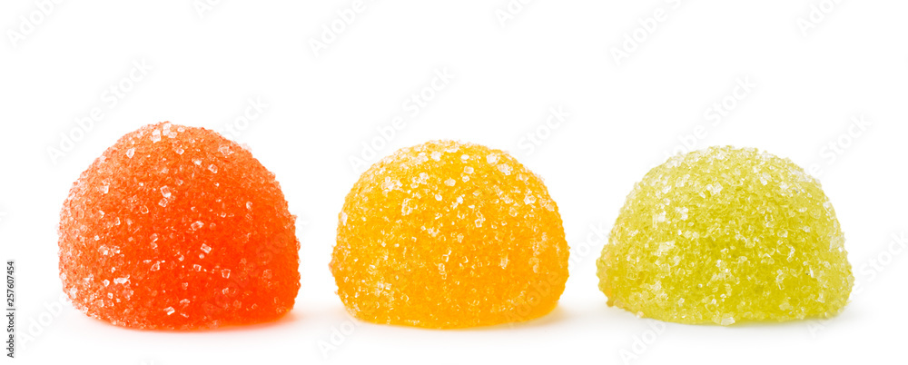 Three multicolored marmalade in sugar on a white, isolated. Three multicolored marmalade in sugar on a white, isolated.