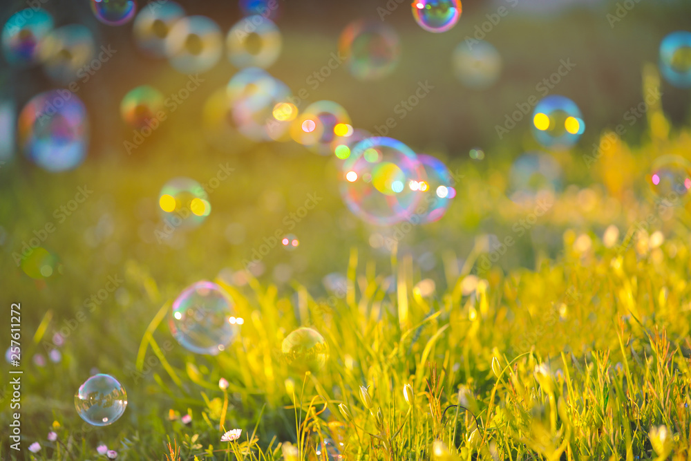 Blurred of floating soap bubbles of different colors and sizes in ...