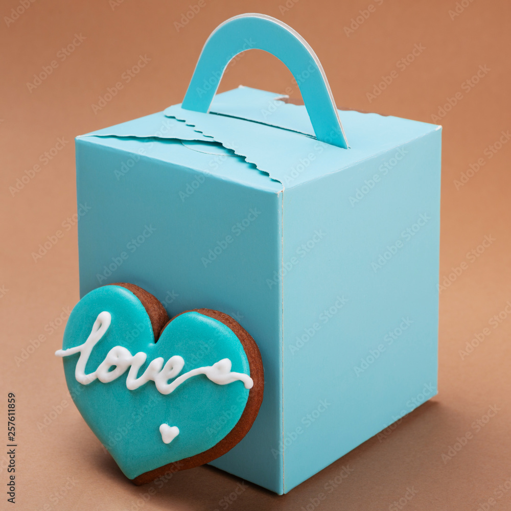 turquoise gift box and turquoise heart-shaped gingerbread, concept of love, relationships