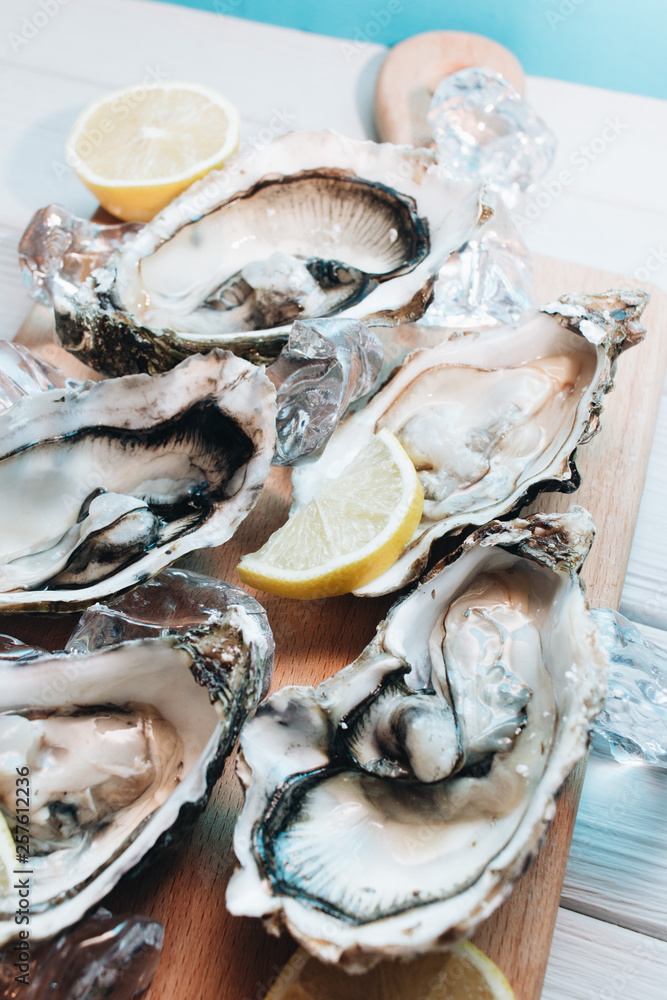 Delicious oysters with lemon, seafood delicacy Delicious oysters with lemon, seafood delicacy