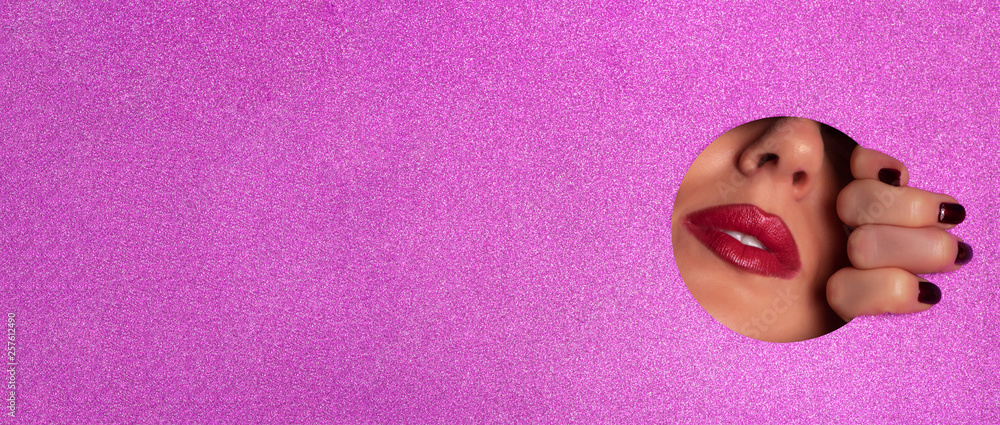 Female fingers, nose and lips with red lipstick through glitter violet paper. Business card of artist, beauty concept. Ready to new year party. Cosmetics sale. Beauty salon advertising banner Female fingers, nose and lips with red lipstick through glitter violet paper. Business card of artist, beauty concept. Ready to new year party. Cosmetics sale. Beauty salon advertising banner