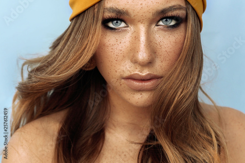 Stampa su tela portrait of beautiful young woman with brown hair and freckles face